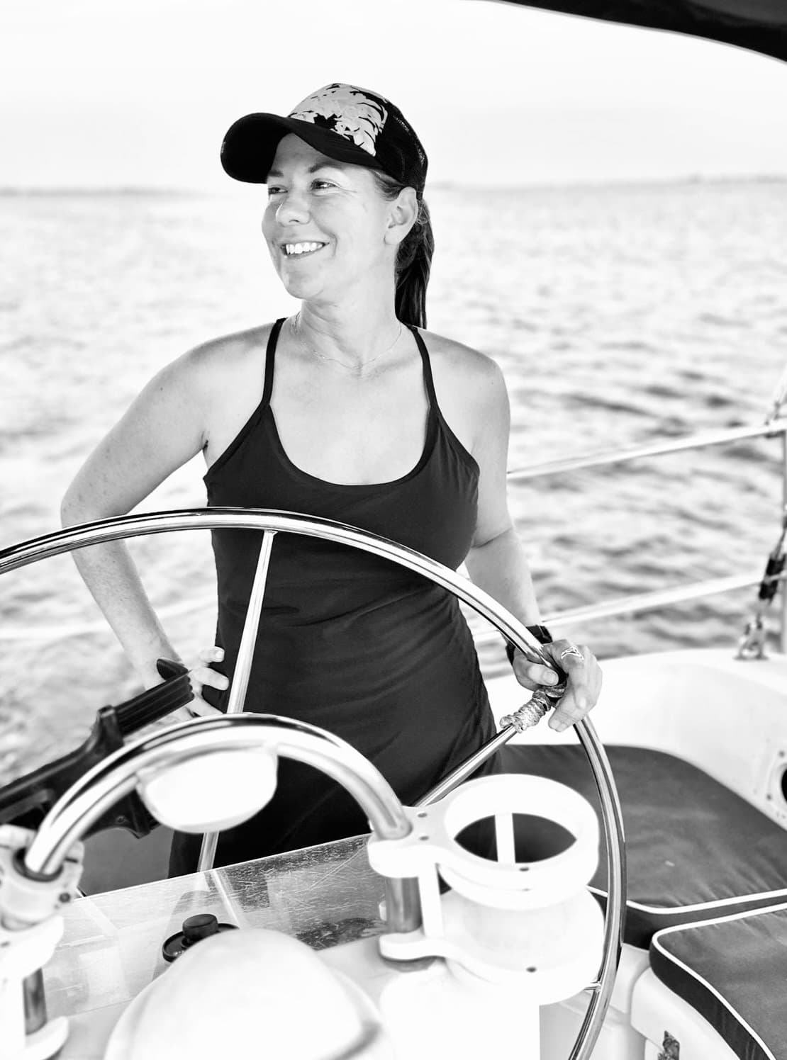 Holly Hillman, meditation guide, at the helm of a sailboat. 