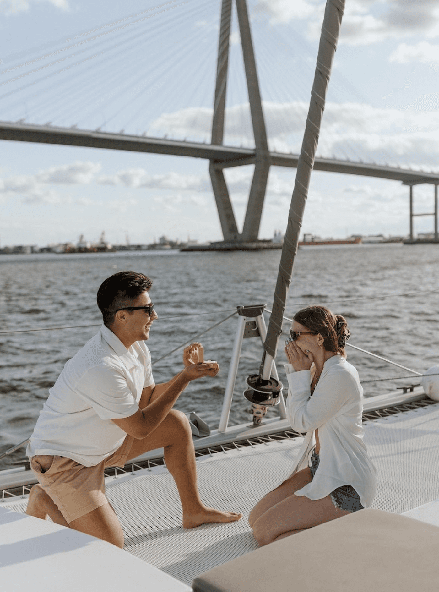 Proposal in front of the Arthur Ravenel Jr. Bridge from a private sailing charter in Charleston